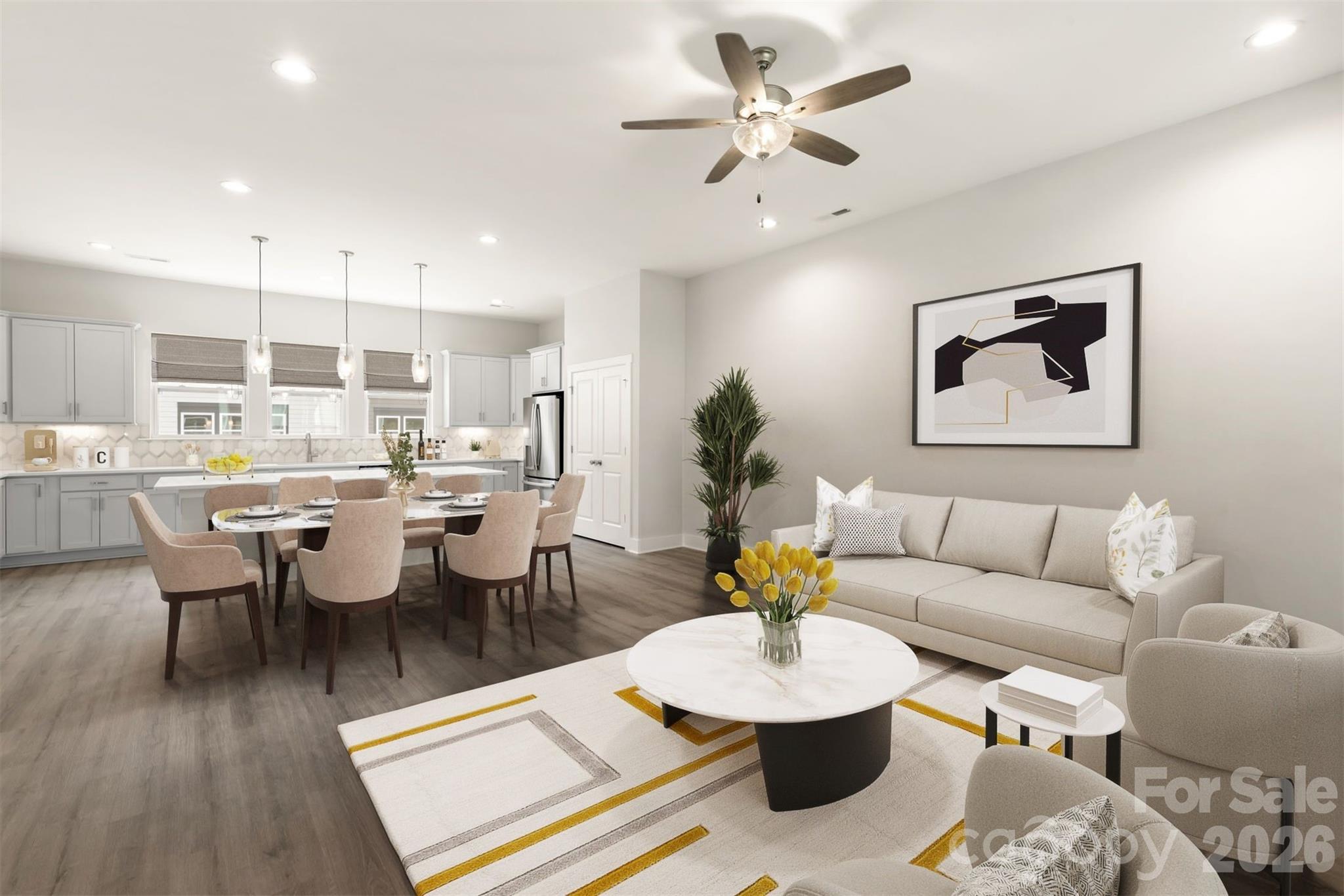a living room with furniture kitchen view and a chandelier