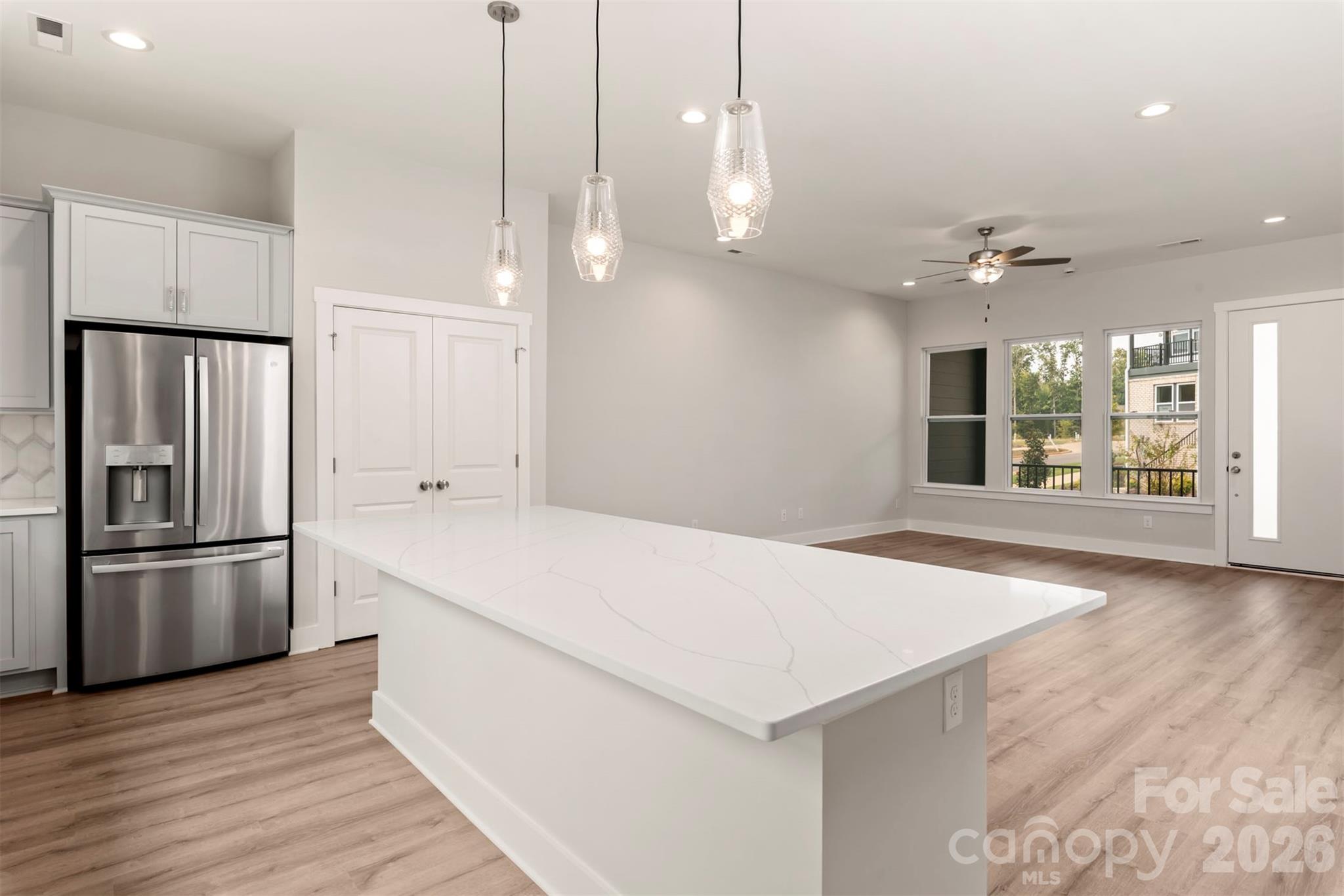 429 Nathaniel Way, Unit BRX0032 Charlotte, NC 28213 - Photo 13 of 43 a kitchen with stainless steel appliances a refrigerator and a hard wood floor