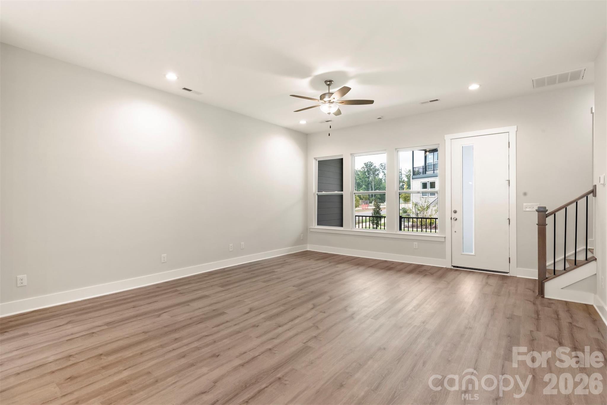 429 Nathaniel Way, Unit BRX0032 Charlotte, NC 28213 - Photo 16 of 43 an empty room with wooden floor and a ceiling fan