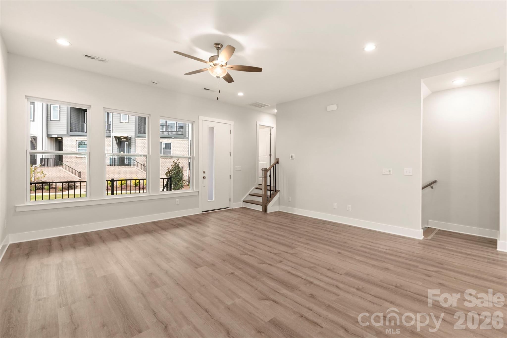 429 Nathaniel Way, Unit BRX0032 Charlotte, NC 28213 - Photo 17 of 43 a view of an empty room with wooden floor and a window