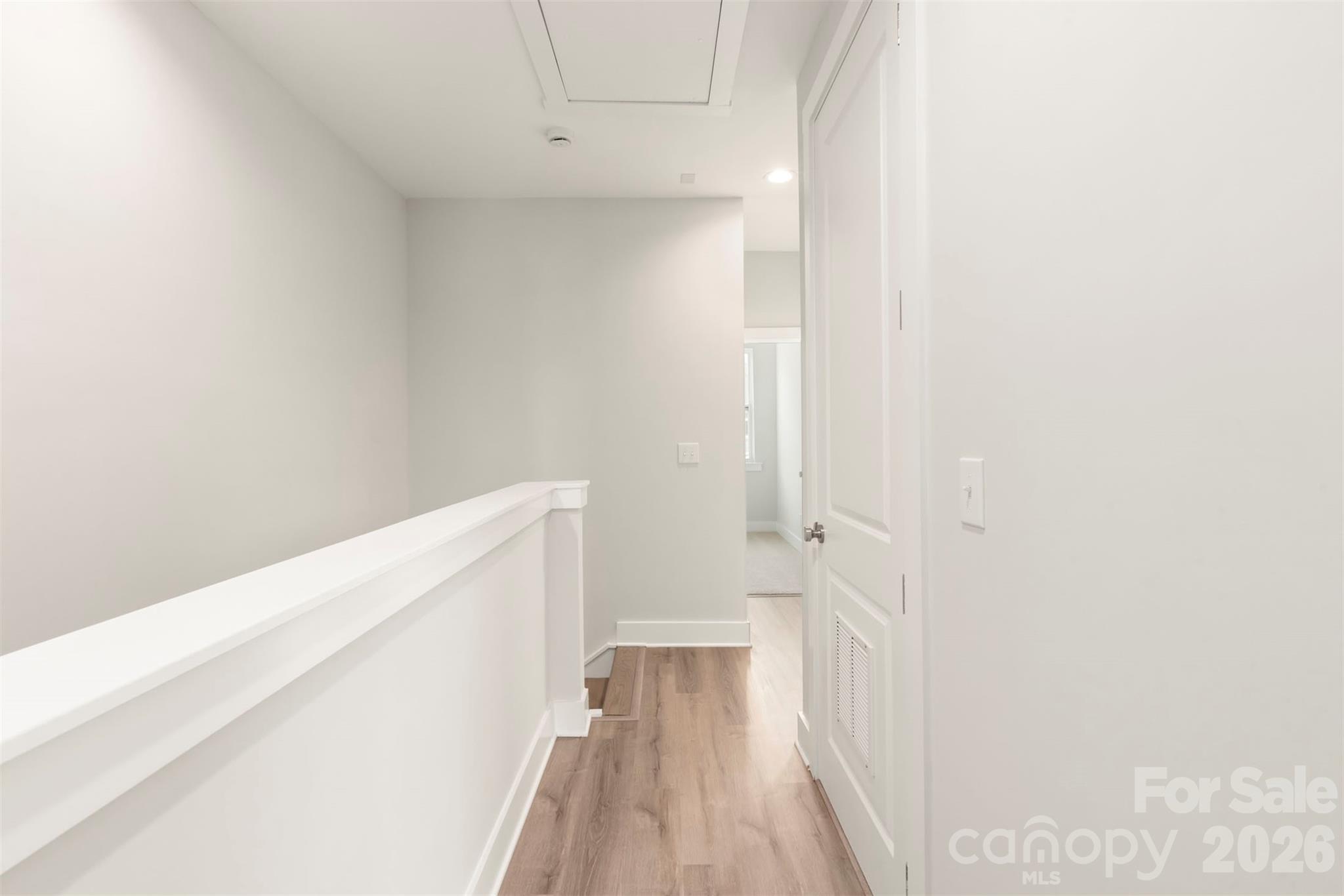 429 Nathaniel Way, Unit BRX0032 Charlotte, NC 28213 - Photo 19 of 43 a view of a room with wooden floor and white walls