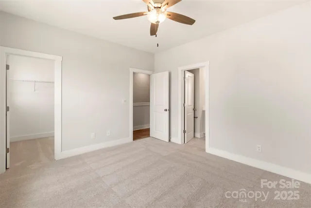 a view of a livingroom with a ceiling fan and a chandelier fan