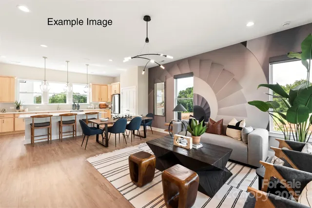 a living room with lots of furniture and a large window