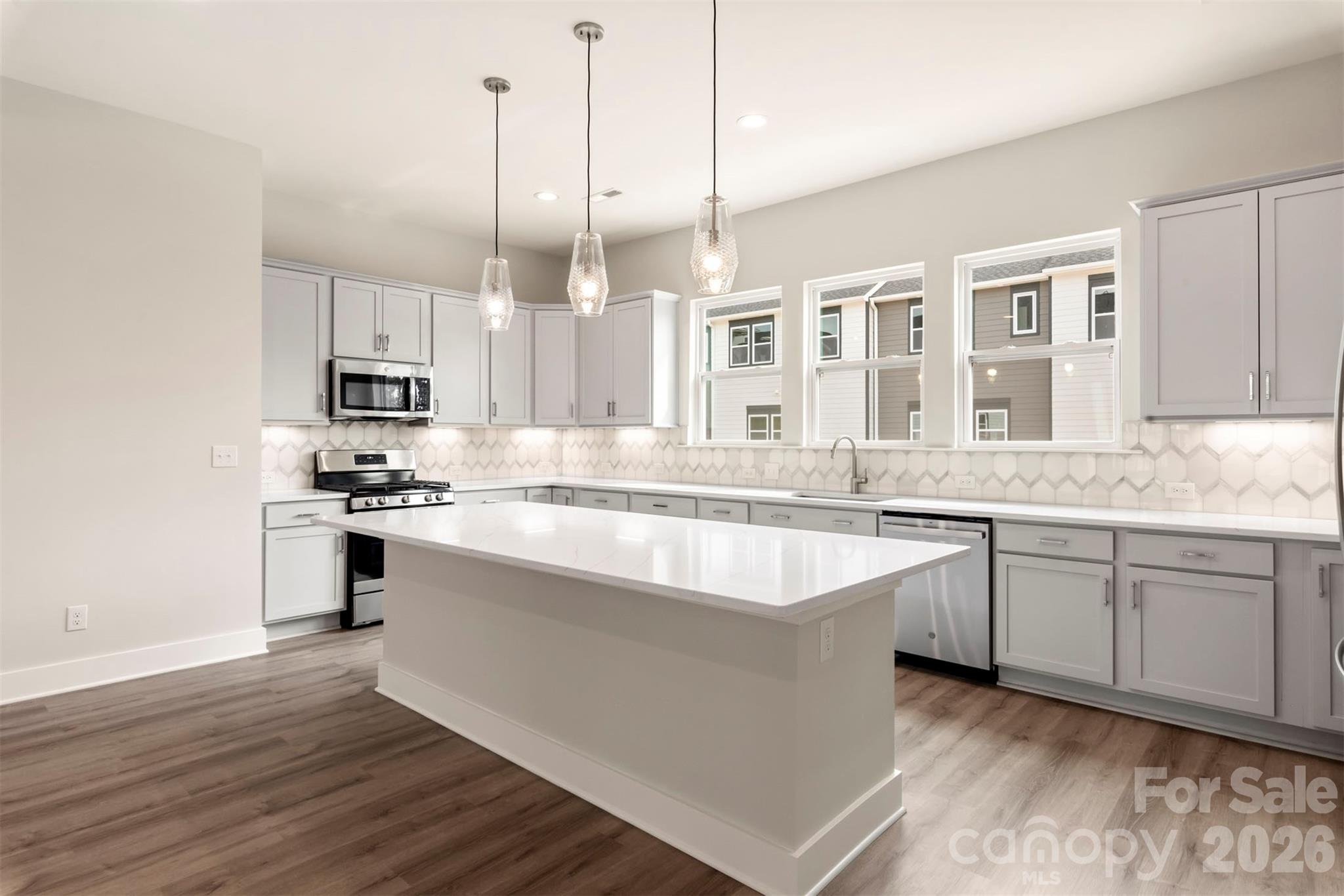 429 Nathaniel Way, Unit BRX0032 Charlotte, NC 28213 - Photo 10 of 43 a large kitchen with granite countertop a sink counter space stainless steel appliances and cabinets