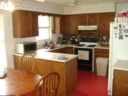 3514 Vine Street McHenry, IL 60050 - Photo 3 of 10 a kitchen that has a sink and a stove in it