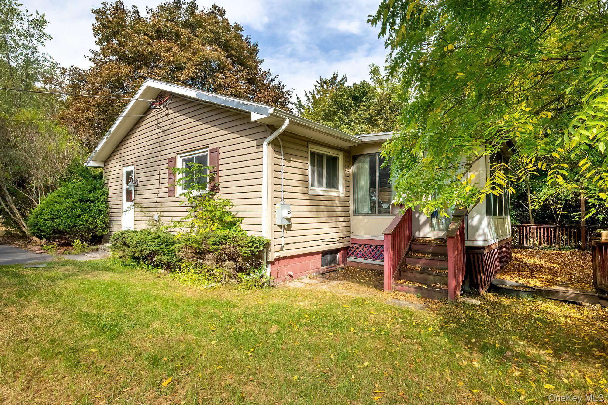 240 Stevers Crossing Road Hudson, NY 12534 - Photo 18 of 21 View of home's exterior with a sunroom, a lawn, and crawl space