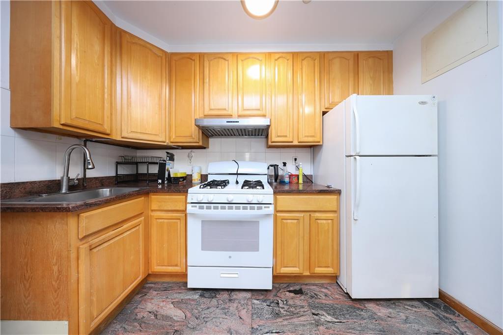 2265 West 7th Street, Unit 3B Brooklyn, NY 11223 - Photo 12 of 17 a kitchen with a refrigerator sink stove and oven