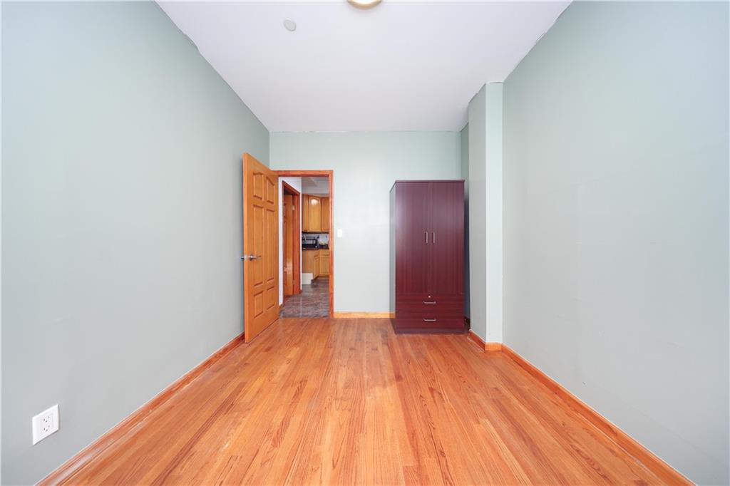 2265 West 7th Street, Unit 3B Brooklyn, NY 11223 - Photo 17 of 17 a view of a room with wooden floor and bathroom