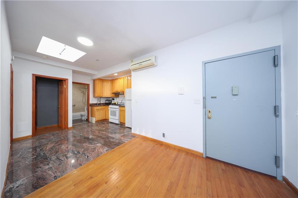 2265 West 7th Street, Unit 3B Brooklyn, NY 11223 - Photo 6 of 17 a view of a kitchen with wooden floor and a window