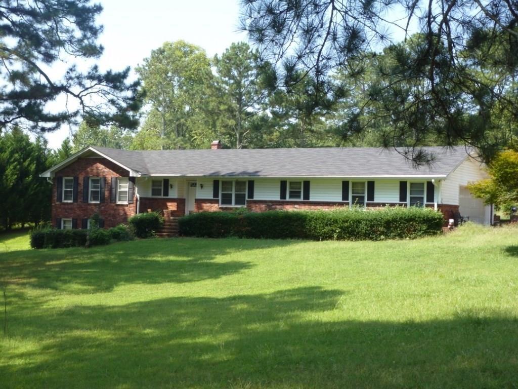 13700 Freemanville Road Milton, GA 30004 - Photo 1 of 1 a front view of a house with a yard and trees