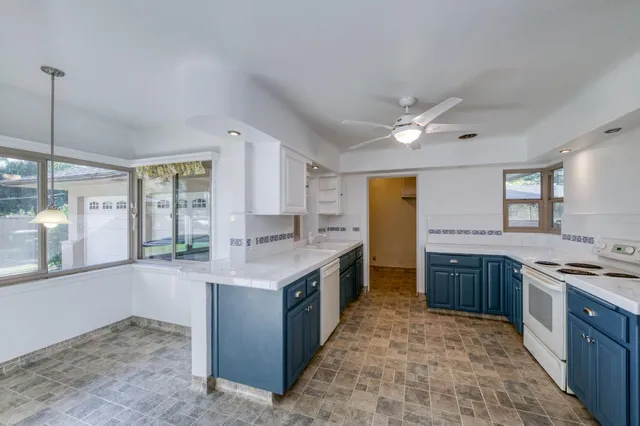 a kitchen with stainless steel appliances granite countertop a stove and a sink