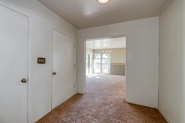 a view of hallway with closet area
