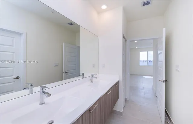 a bathroom with a double vanity sink
