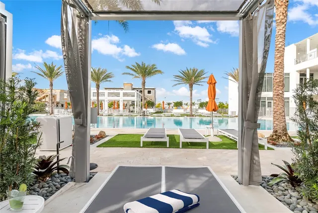 a view of swimming pool with seating area