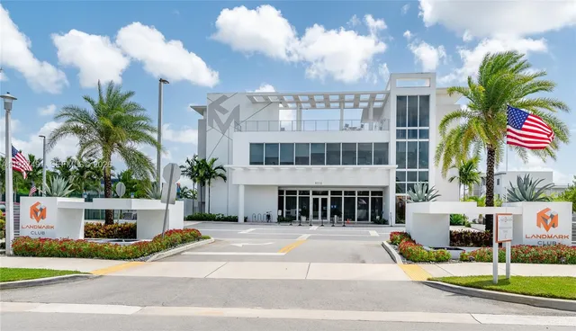 a view of a house with a patio and a yard