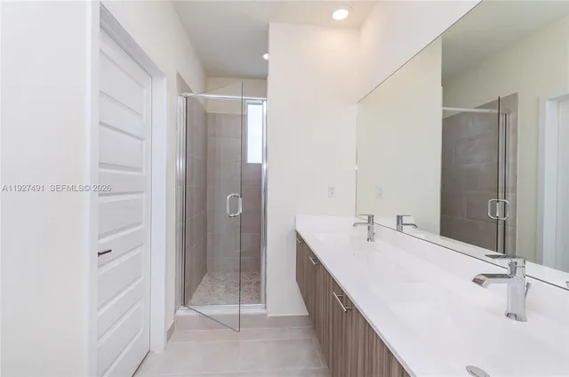 a spacious bathroom with a bathtub sink and mirror
