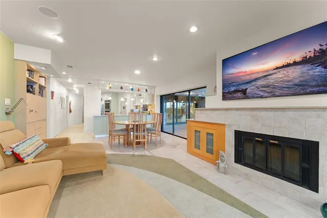 a view of a dining room with furniture a kitchen and chandelier