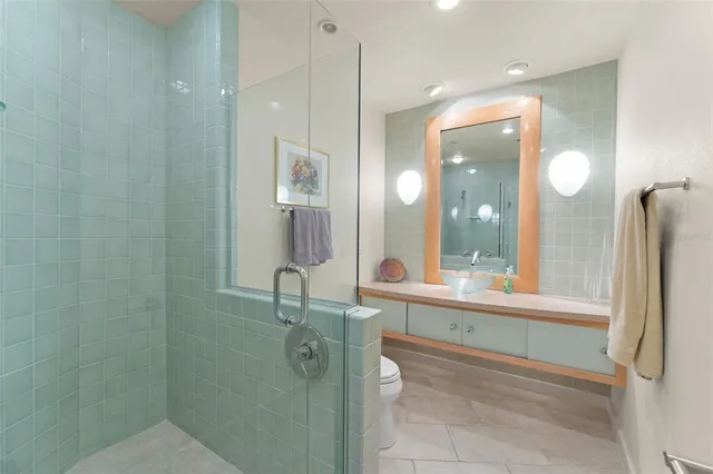 a living room with furniture a flat screen tv and kitchen view