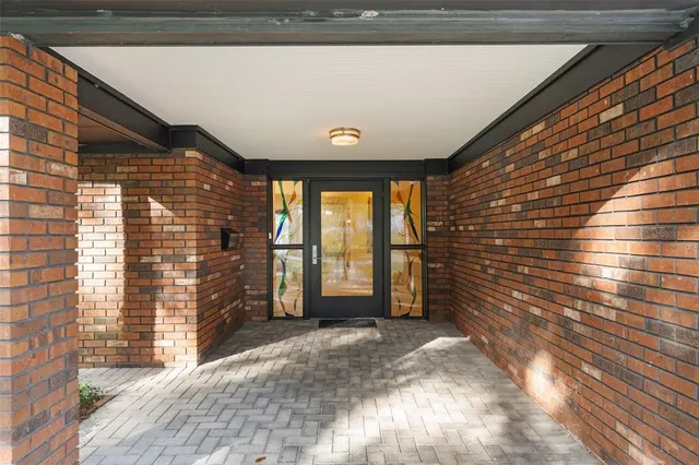 a view of a hallway to a livingroom with furniture