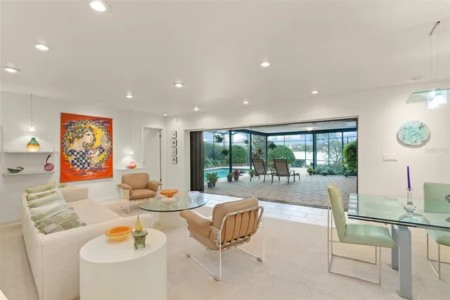 a living room with kitchen island furniture and a chandelier