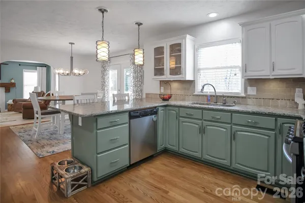 a view of a dining room with furniture wooden floor and chandelier