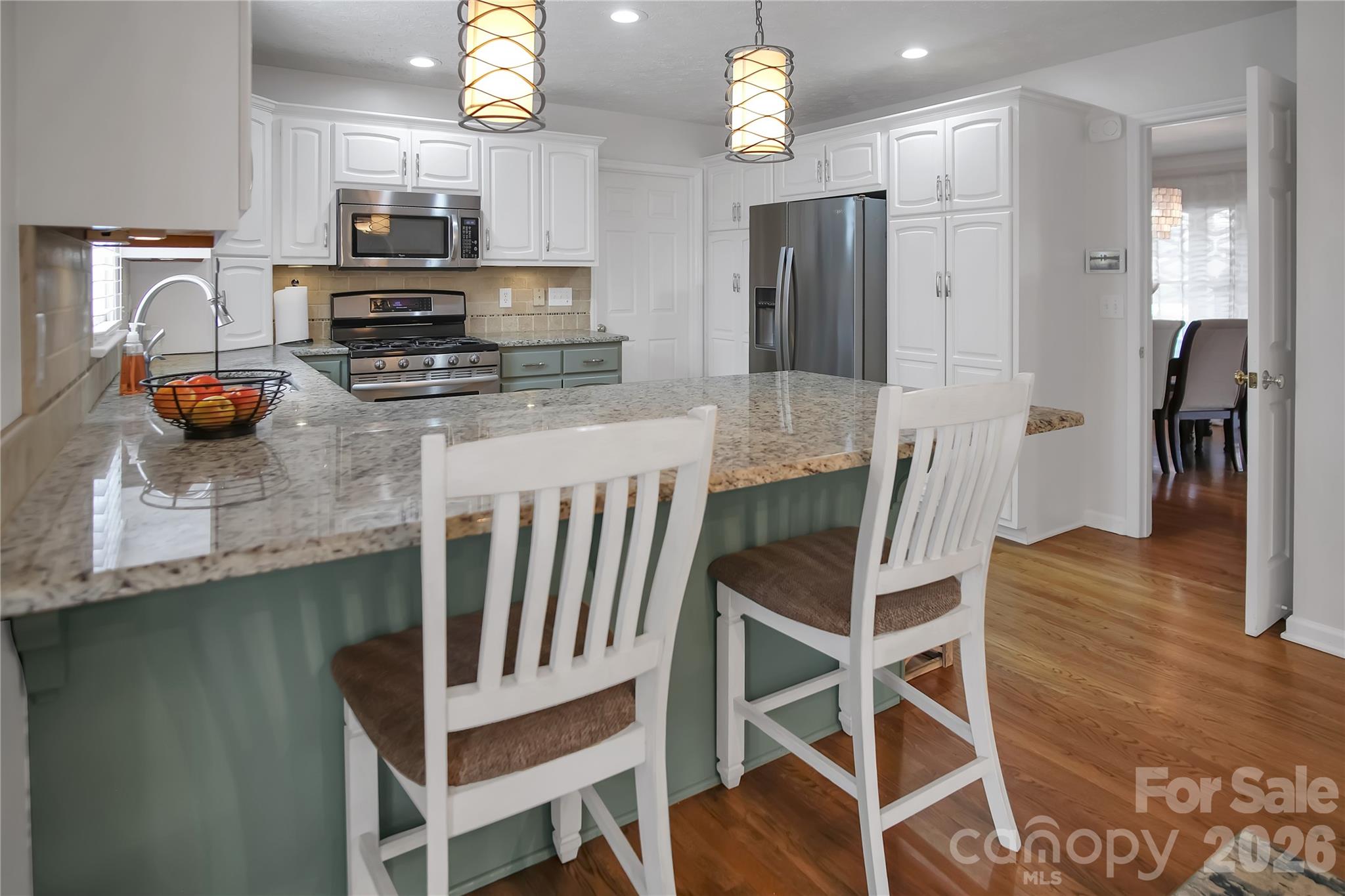 120 Oak Point Drive Cherryville, NC 28021 - Photo 17 of 44 a kitchen with stainless steel appliances a dining table chairs microwave and sink