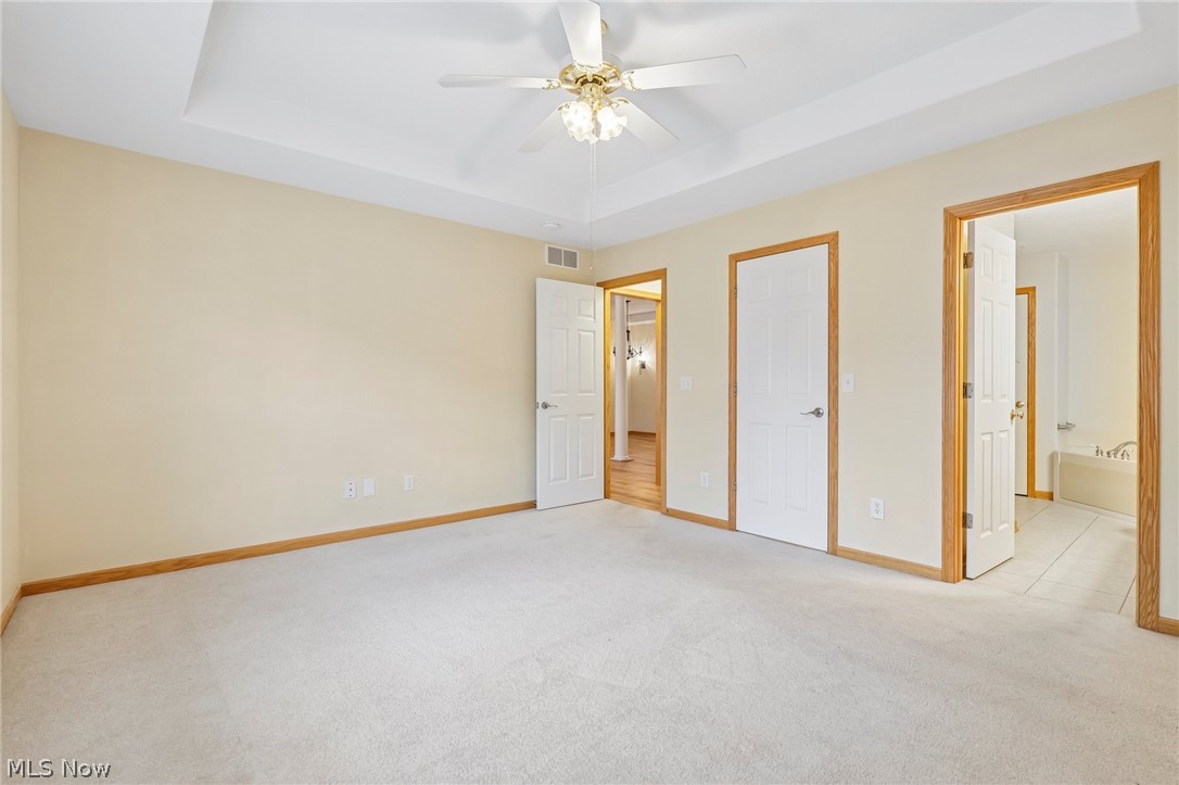 7007 Clingan Road, Unit 85 Youngstown, OH 44514 - Photo 31 of 46 Recessed ceiling detail, ceiling fan with light fixture, light-toned walls, contrasting wood trim, and light-colored carpeting