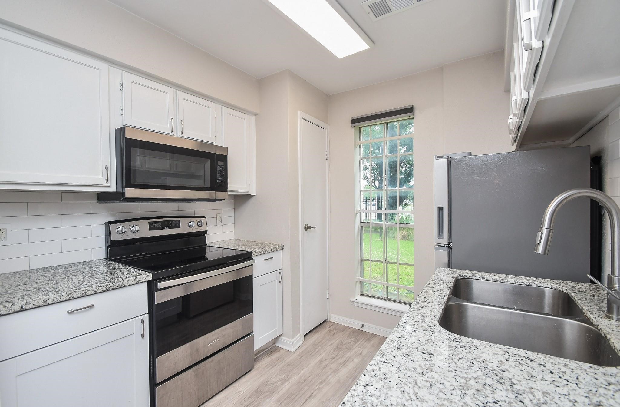 2120 El Paseo Street Houston, TX 77054 - Photo 11 of 31 a kitchen with a sink wooden floor and a window