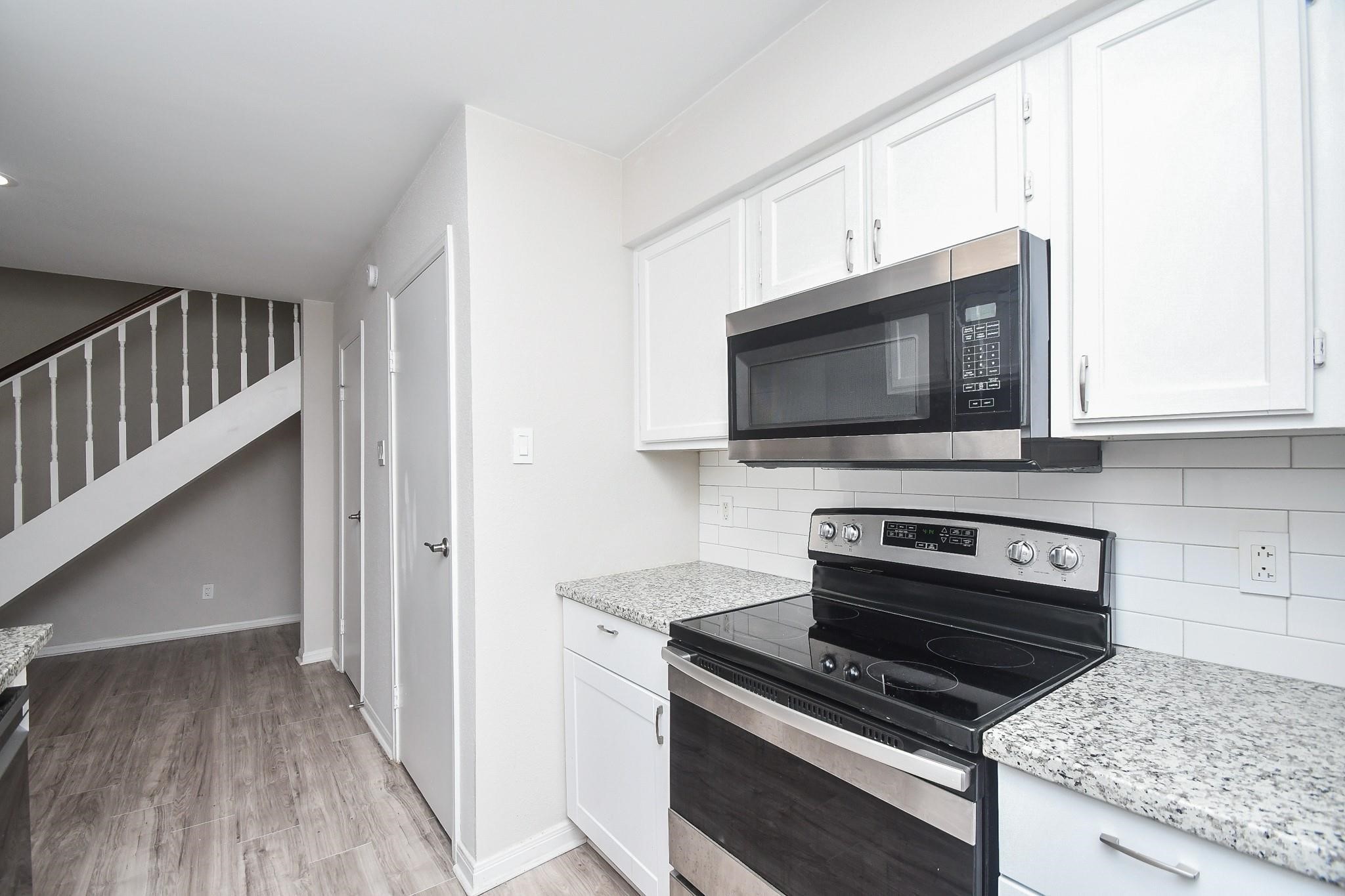 2120 El Paseo Street Houston, TX 77054 - Photo 13 of 31 a kitchen with a stove and a microwave