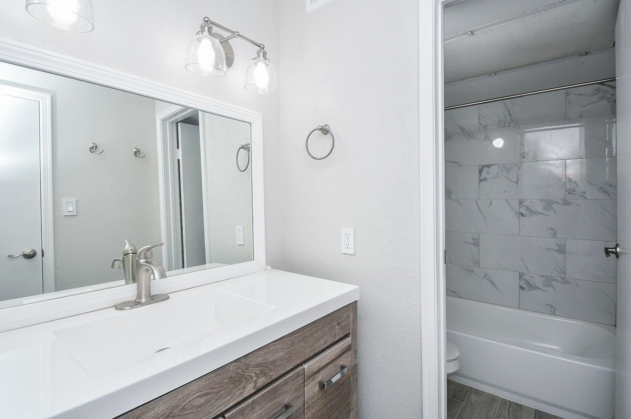 2120 El Paseo Street Houston, TX 77054 - Photo 25 of 31 a bathroom with a sink and a mirror