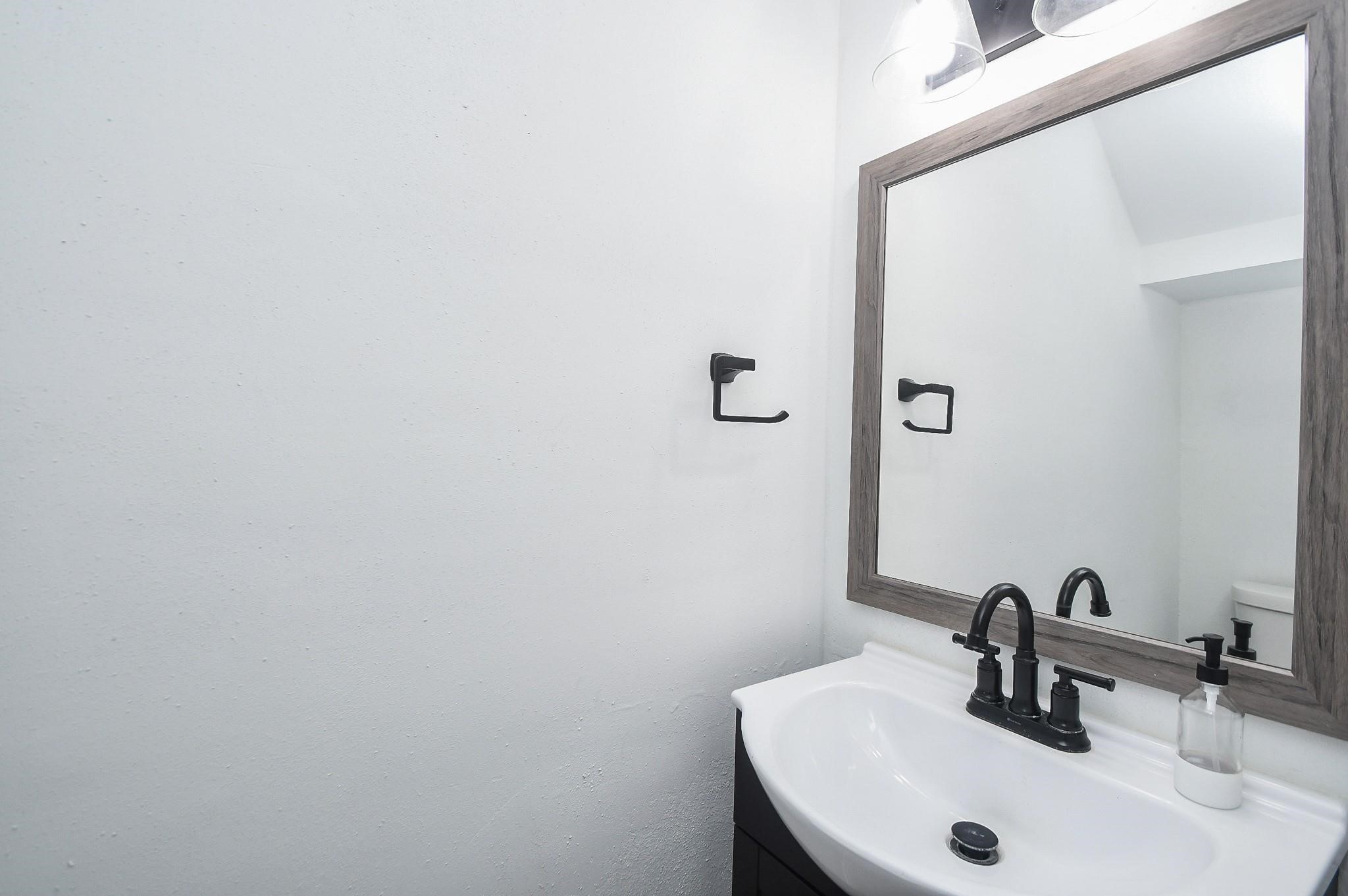 2120 El Paseo Street Houston, TX 77054 - Photo 29 of 31 a bathroom with a sink and a mirror