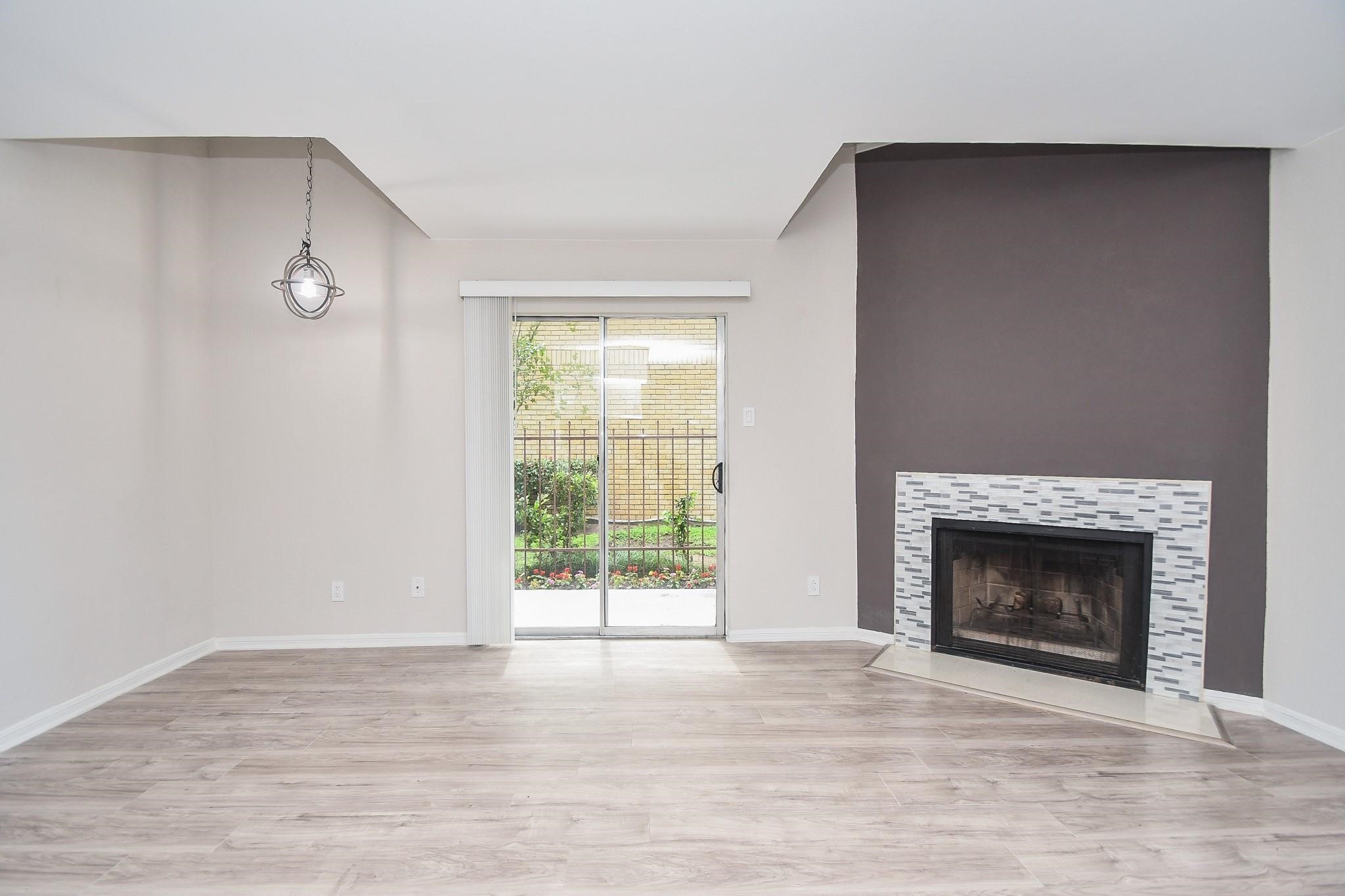 2120 El Paseo Street Houston, TX 77054 - Photo 6 of 31 a view of empty room with wooden floor and fireplace