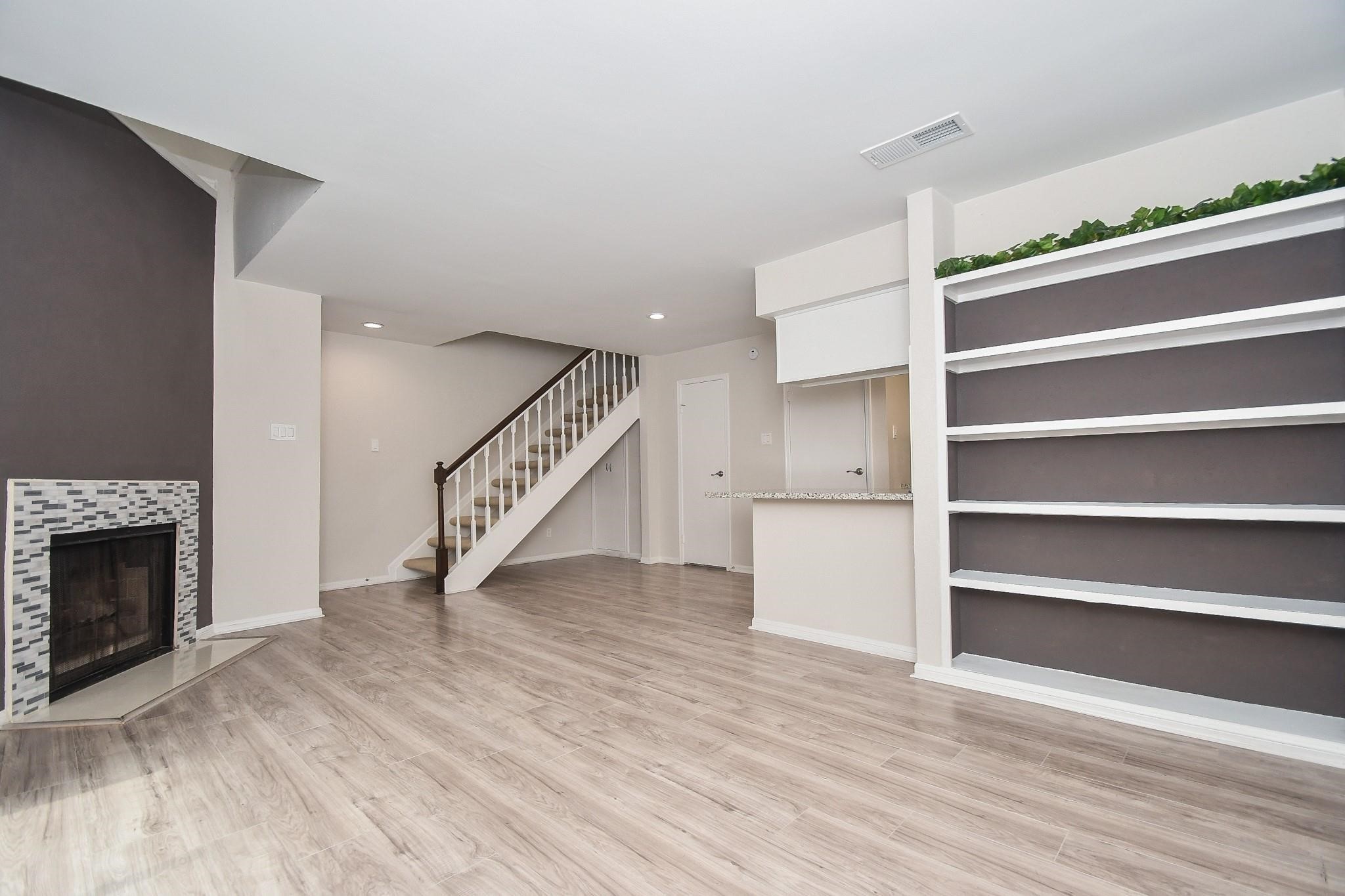2120 El Paseo Street Houston, TX 77054 - Photo 8 of 31 a view of an empty room with wooden floor and a fireplace
