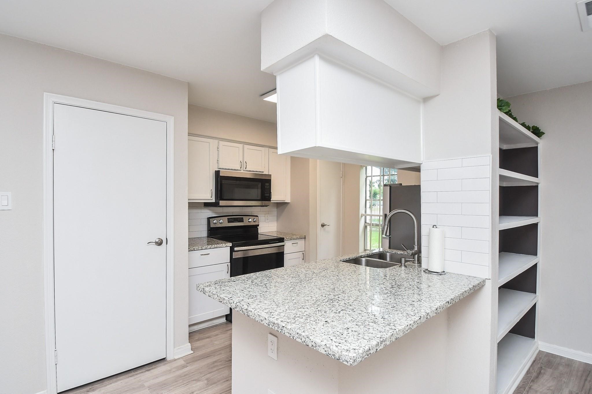 2120 El Paseo Street Houston, TX 77054 - Photo 10 of 31 a kitchen with stainless steel appliances granite countertop a sink refrigerator and microwave