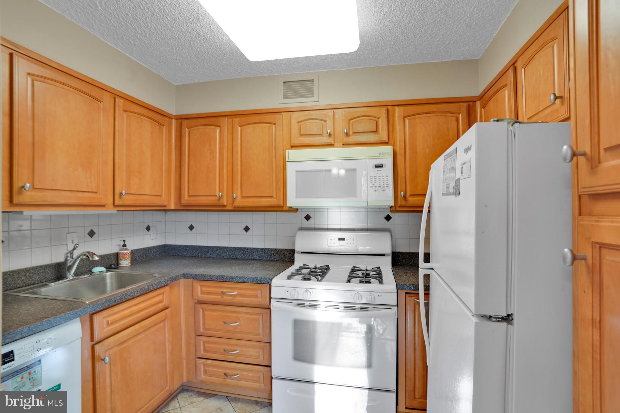 2100 Washington Avenue, Unit 2B Silver Spring, MD 20910 - Photo 15 of 34 a kitchen with stainless steel appliances a refrigerator sink and cabinets