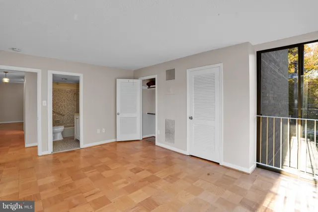 a view of an empty room with glass door