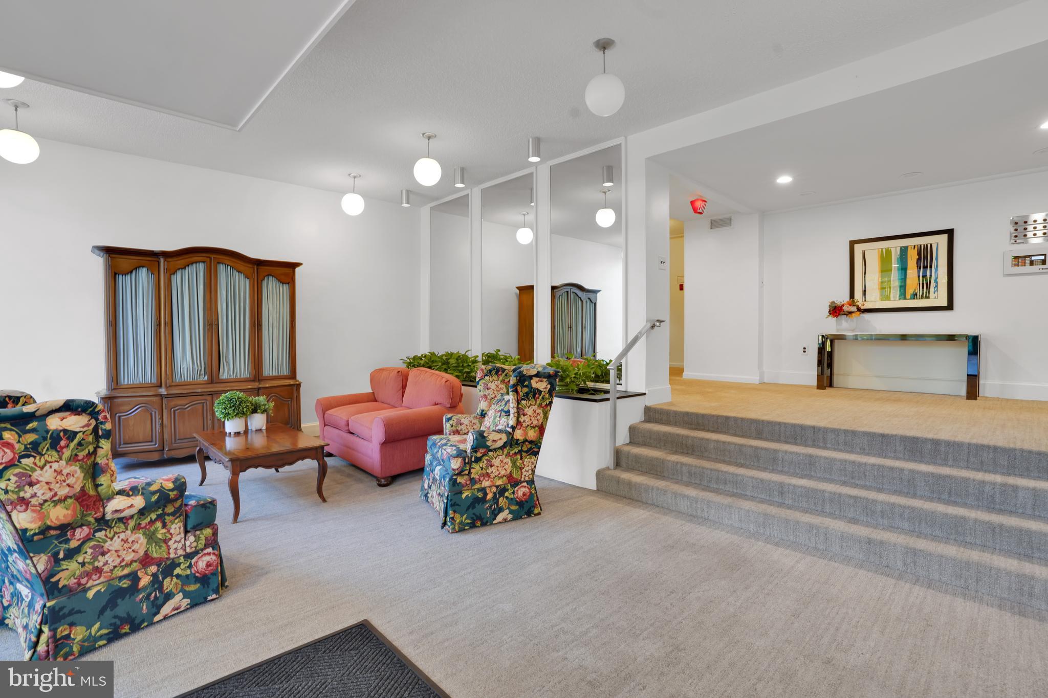 2100 Washington Avenue, Unit 2B Silver Spring, MD 20910 - Photo 5 of 34 a living room with furniture and a chandelier