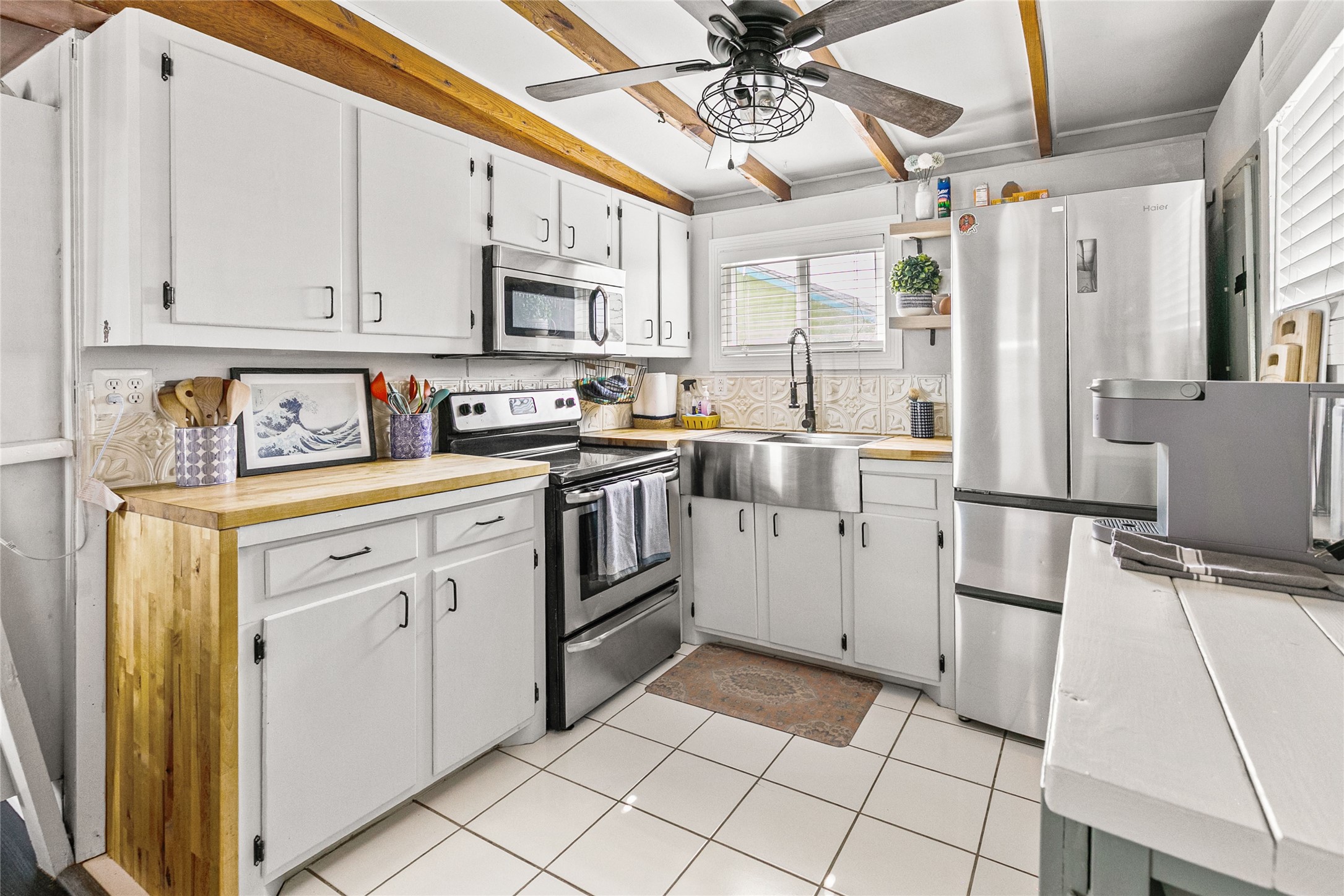 311 Olive Street Surfside Beach, TX 77541 - Photo 11 of 29 a kitchen with stainless steel appliances a refrigerator sink and microwave