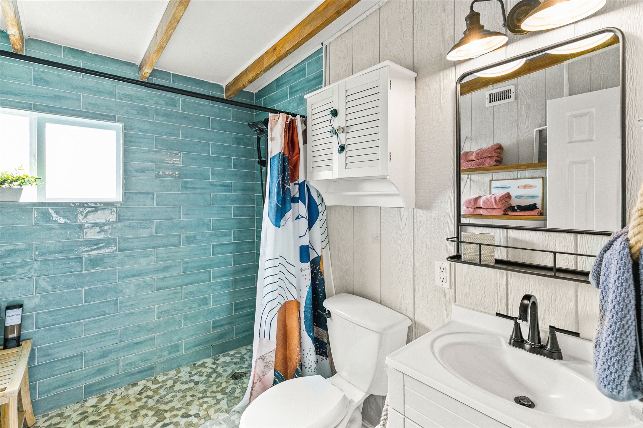 311 Olive Street Surfside Beach, TX 77541 - Photo 15 of 29 a bathroom with a sink a toilet and shower