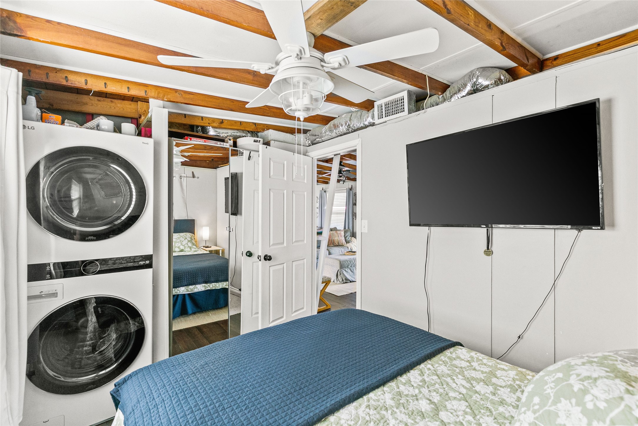 311 Olive Street Surfside Beach, TX 77541 - Photo 18 of 29 a view of a bedroom with washer and dryer