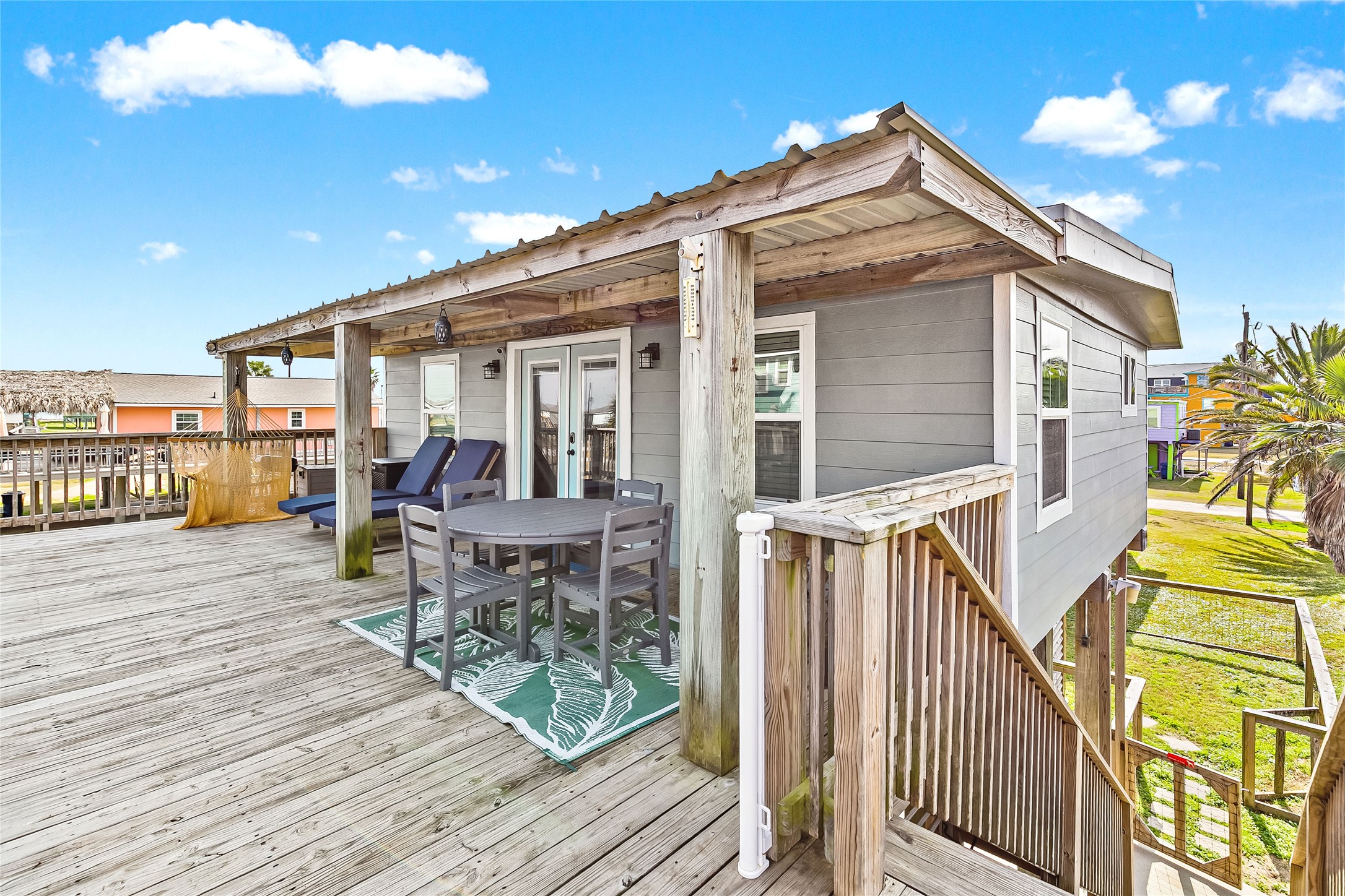 311 Olive Street Surfside Beach, TX 77541 - Photo 2 of 29 a view of a house with wooden deck and furniture