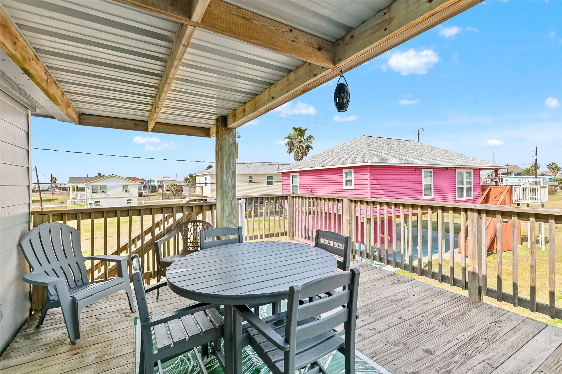 311 Olive Street Surfside Beach, TX 77541 - Photo 22 of 29 a view of a balcony with a table and chairs