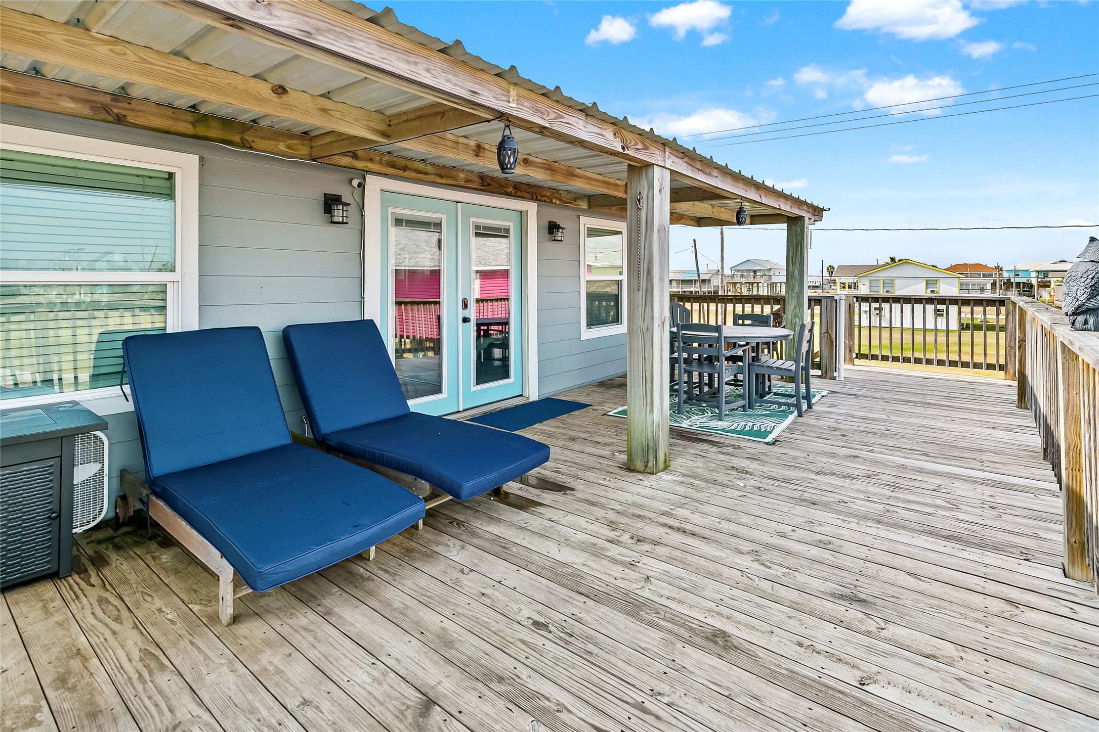 311 Olive Street Surfside Beach, TX 77541 - Photo 24 of 29 a balcony with furniture and wooden floor