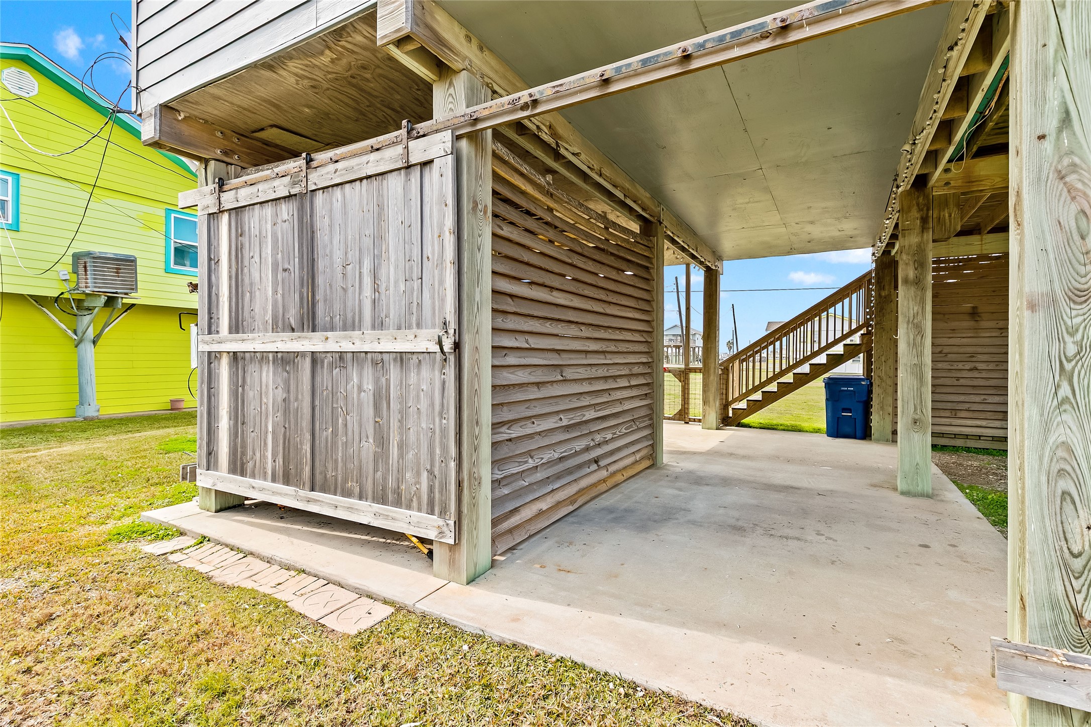 311 Olive Street Surfside Beach, TX 77541 - Photo 6 of 29 a view of a house with wooden walls