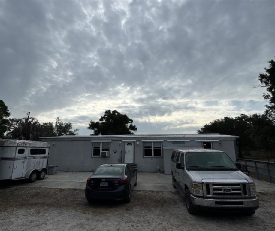 2288 Northwest Haile Dean Road Arcadia, FL 34266 - Photo 1 of 1 a car parked in front of a white house