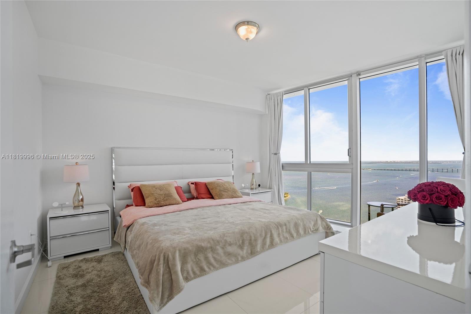 485 Brickell Avenue, Unit 3608 Miami, FL 33131 - Photo 20 of 43 a bedroom with a balcony a bed and a large window