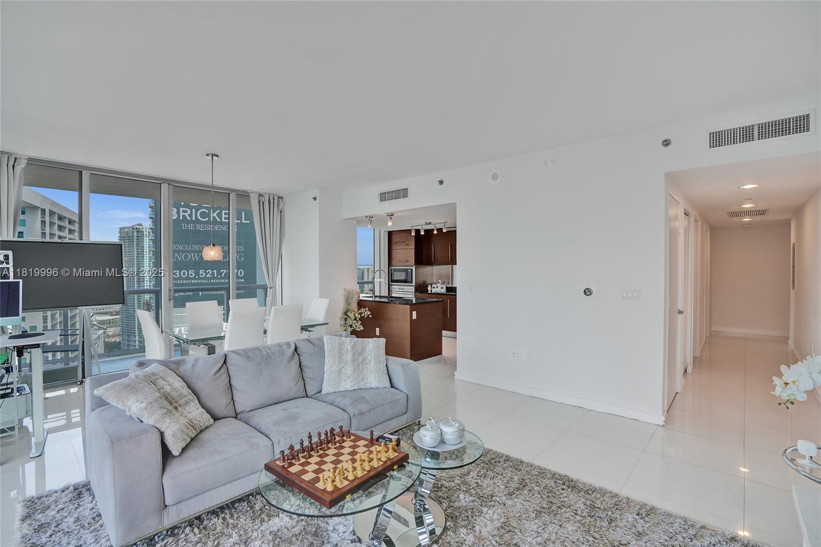 485 Brickell Avenue, Unit 3608 Miami, FL 33131 - Photo 2 of 43 a living room with furniture and a flat screen tv