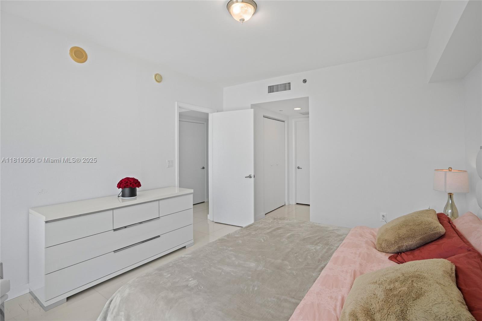 485 Brickell Avenue, Unit 3608 Miami, FL 33131 - Photo 23 of 43 a bedroom with a bed and closet