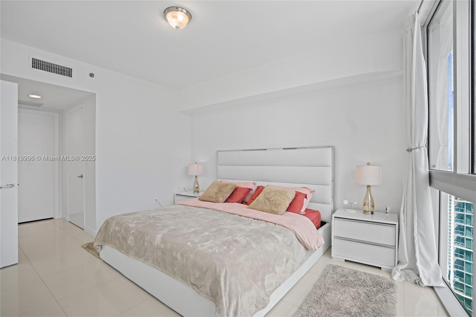 485 Brickell Avenue, Unit 3608 Miami, FL 33131 - Photo 24 of 43 a bedroom with a bed and a window