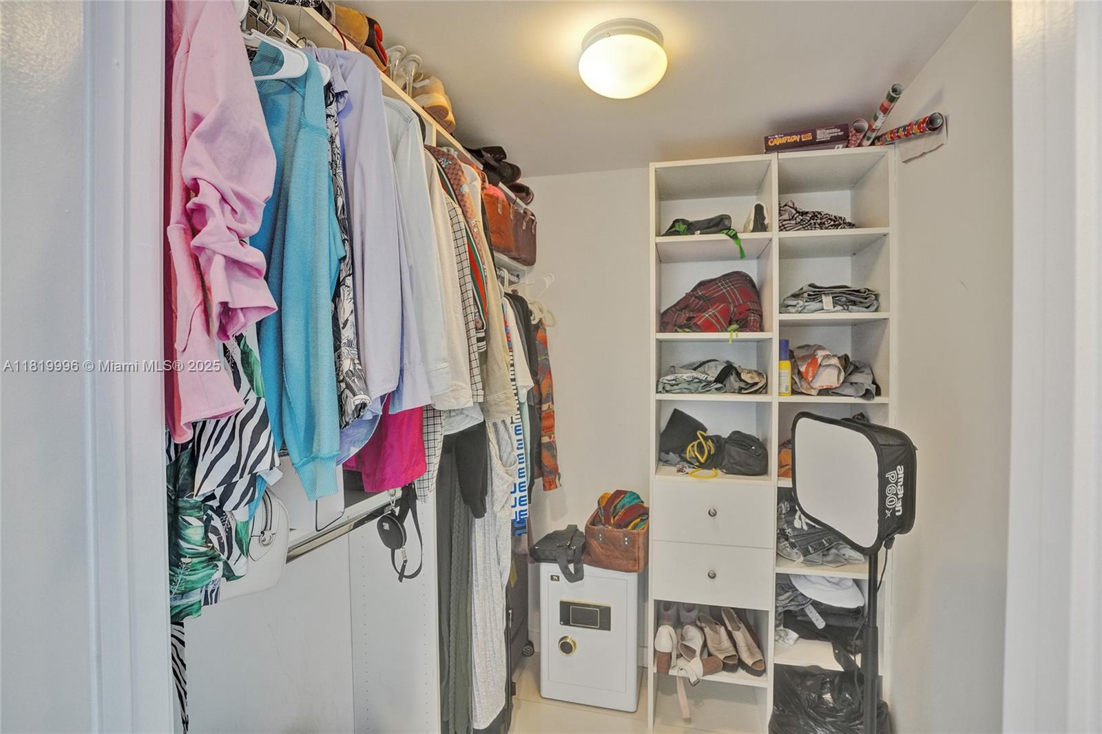 485 Brickell Avenue, Unit 3608 Miami, FL 33131 - Photo 25 of 43 a view of walk in closet with clothes and shoes